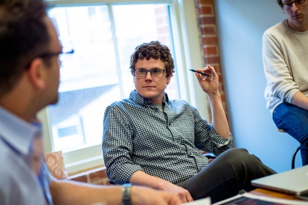 A business student listens to a discussion in his cohort