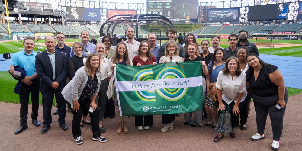 CSU College of Business faculty, staff and MBA students in the College's business immersion course pose for a photo on the field at the Chicago White Sox's baseball stadium.