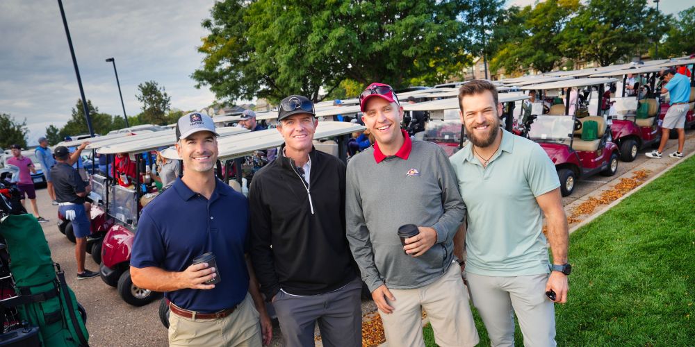 A group of men pose for a photo at the Everitt Real Estate Center's annual golf tournament.