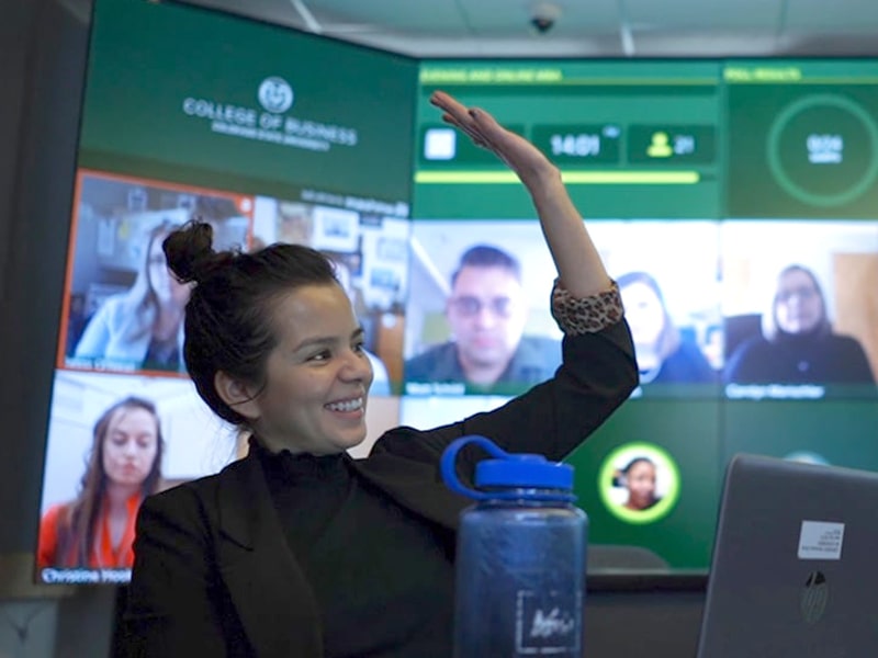 A student raises her hand during an Evening MBA class.