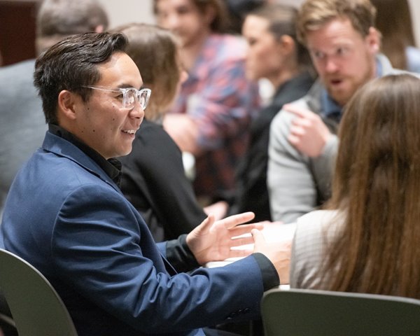 Two people chat at a CSU College of Business event.