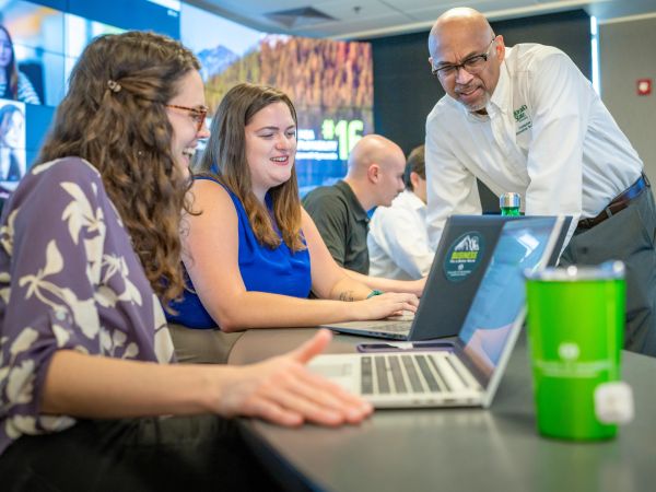 Professor Leo Vijayasarathy, PhD. discusses an assignment with two MBA students in class.