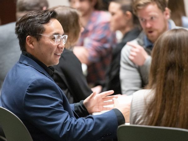 Two people chat at a CSU College of Business networking event.