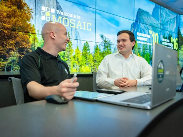 Two Evening MBA students discuss an assignment in class.