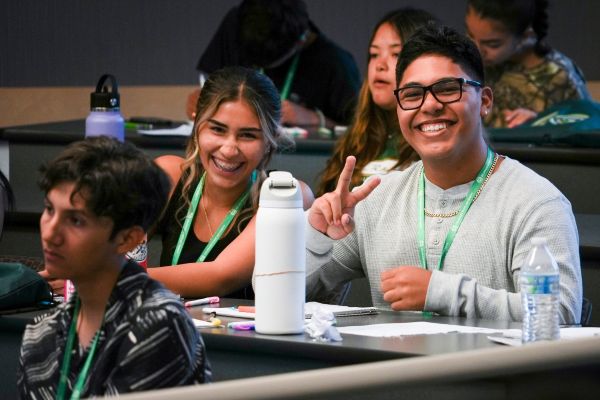 Two high school students pose for a photo during the First-Generation Business Summit at the CSU College of Business.