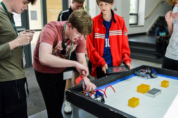 A group of high school students work on a robotics project during the IT in Business summer event at the CSU College of Business.