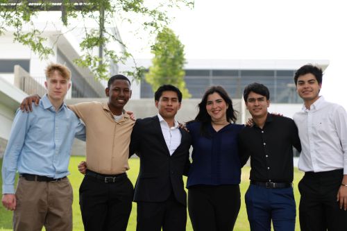 A group of young students pose for a photo outside Canvas Stadium during the Global Business Academy at the CSU College of Business.