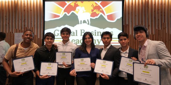 Global Business Academy students pose for a photo with their program completion certificates.