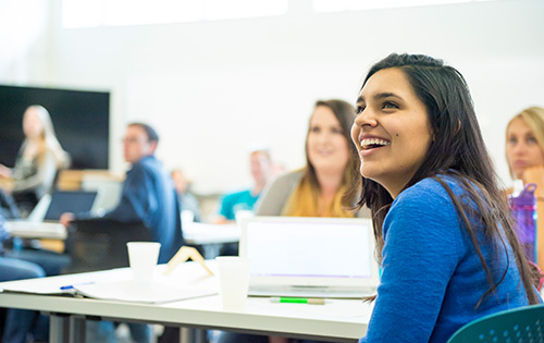 A student smiles in class.