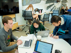 Business students share ideas during a project