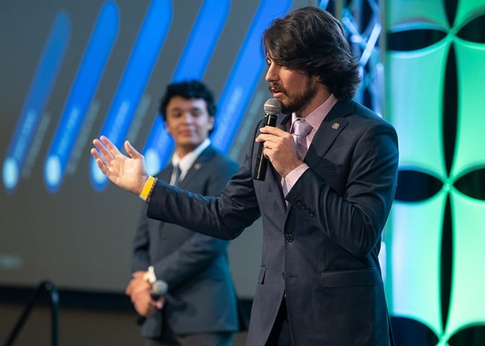 A student presents to a panel of judges at the Venture Rams Business SHowcase.