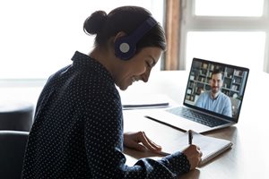 An online MBA student has a video call with another student