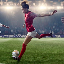 A soccer player kicks the ball