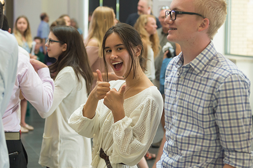 A high school students gives a thumbs up during Global Business Academy