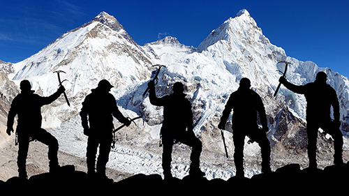 Mountain climbers in front of a mountain vista