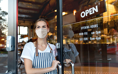 A business owner wearing a mask