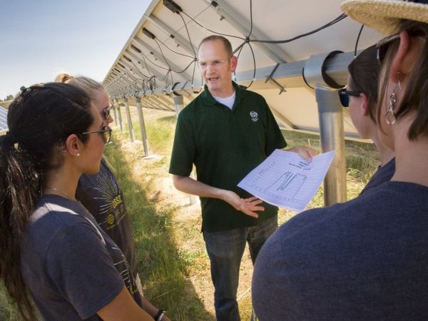 Impact MBA students visiting a solar farm.