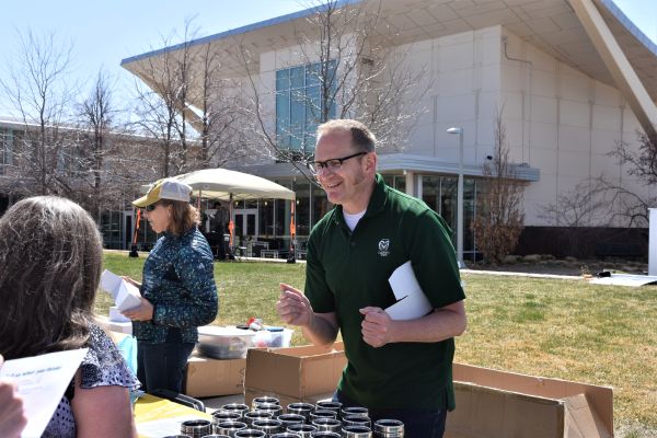 CSU Campus Energy Coordinator Stacey Baumgarn helps out at an Earth Day Event outside the Lory Student Center.