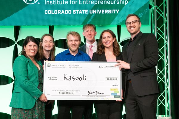 A group of students pose with a giant check and Institute For Entrepreneurship staff after winning the second-place prize in the 2025 Venture Rams Business Showcase.