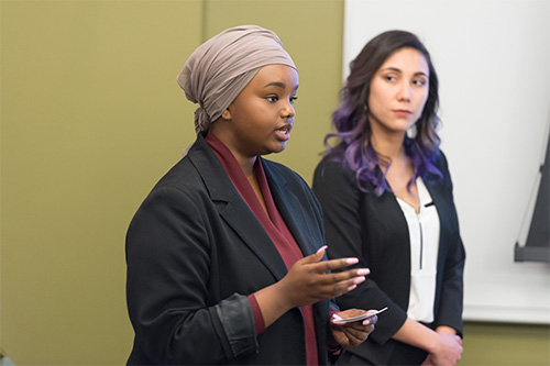 Two students present at an HR case competition