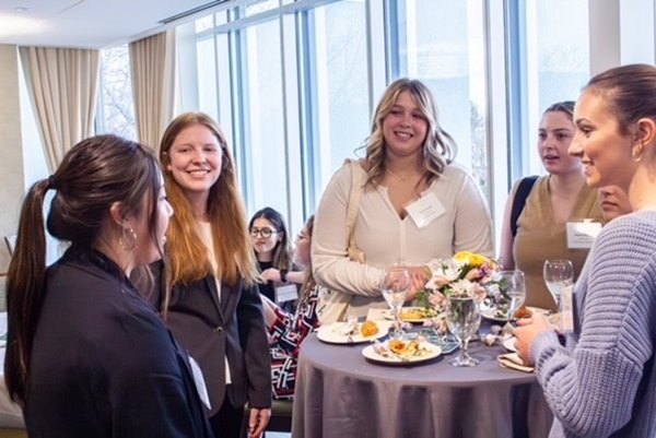 Students chat at a Women in Business Association event.