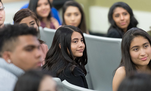 Business students watch a guest speaker