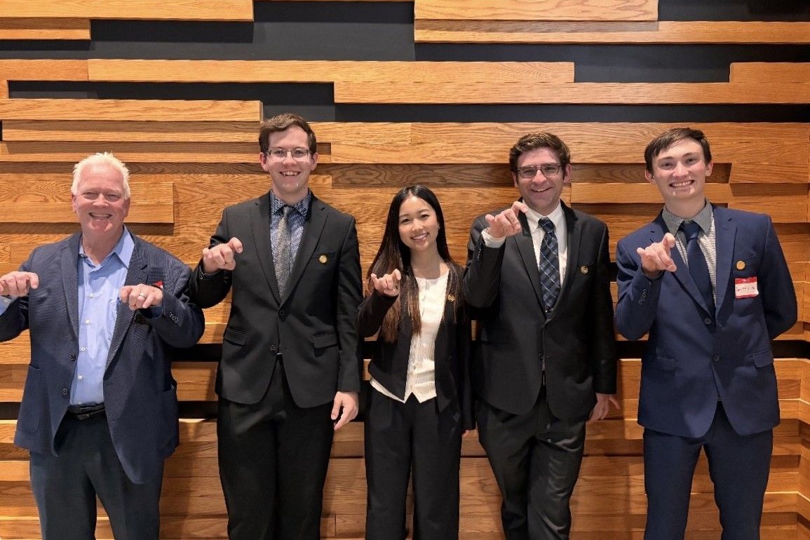 CSU accounting students pose for a photo with a trophy for winning a case competition.