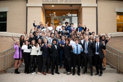 Sales Club members posing for a photo on the steps outside Rockwell Hall.