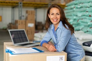 woman using laptop in a warehouse